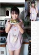 A woman holding a plate of food in a kitchen.