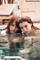 A couple of young women in a swimming pool.