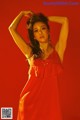 A woman in a red dress posing for a picture.