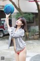 A woman in a red bikini holding a basketball.